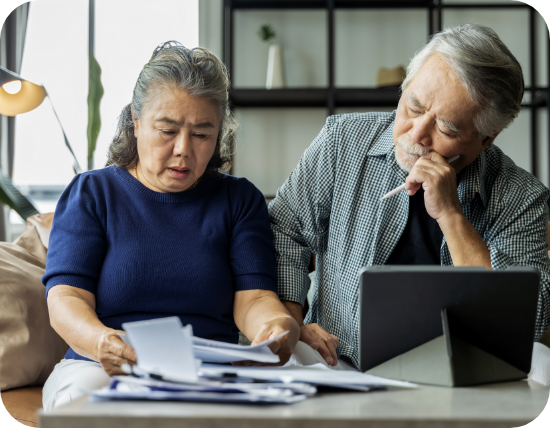 Older asian couple looking though paperwork